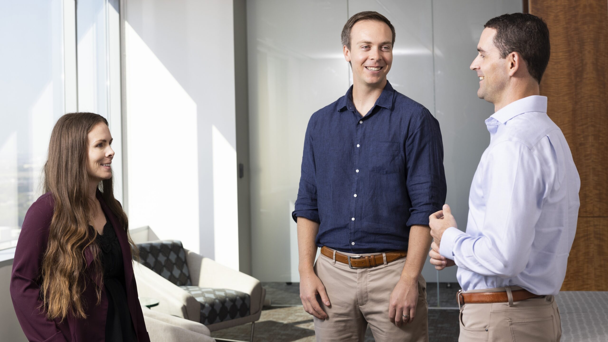 Three employees in conversation.