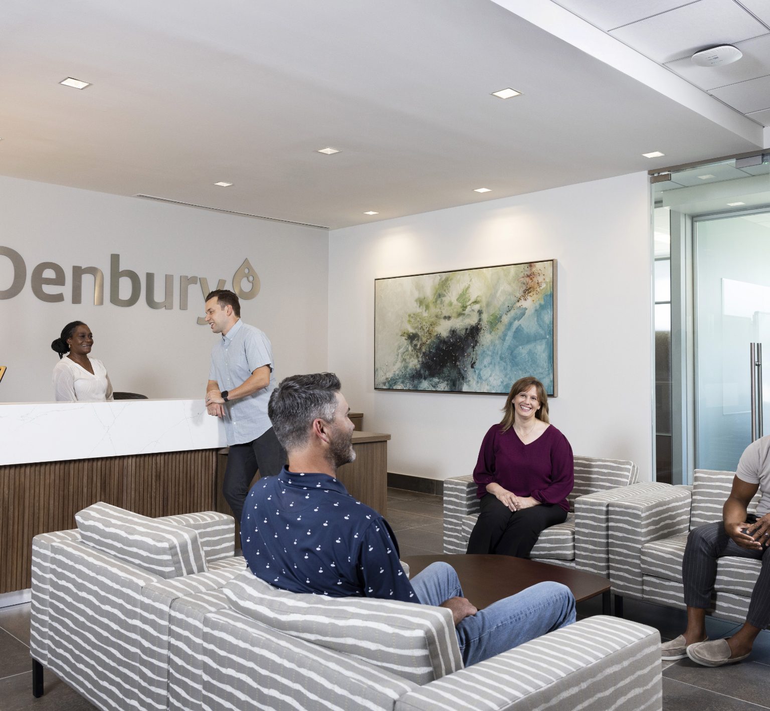 People having conversations in Denbury's lobby.