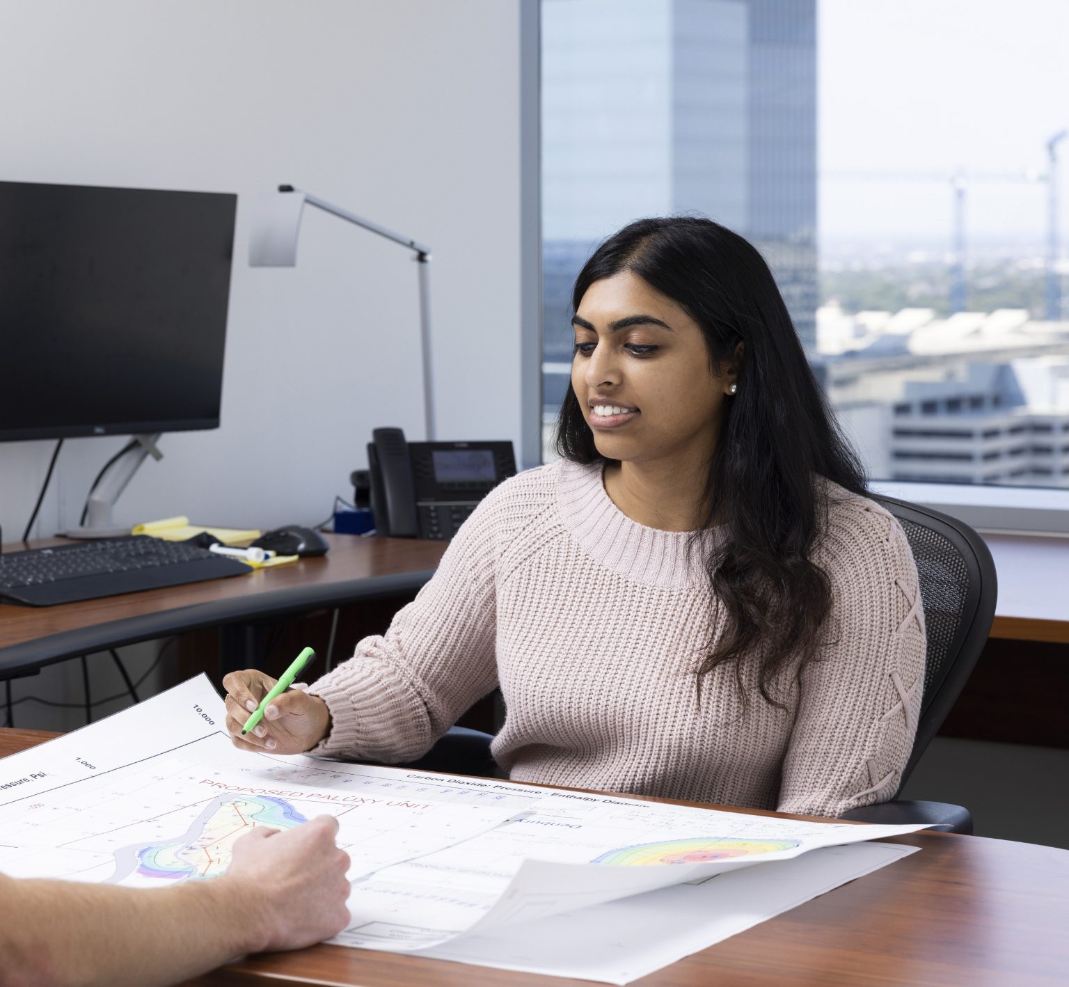 Two people collaborating over a map.